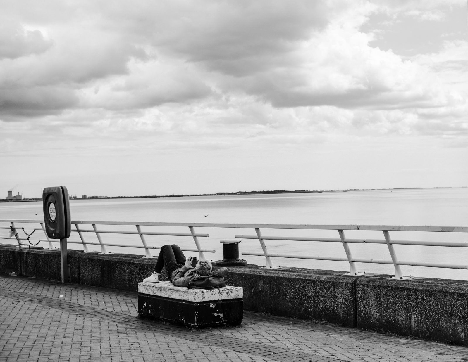 A man laid down on a bench in Hull