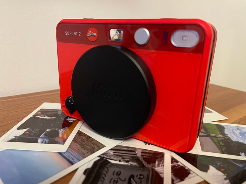 Leica Sofort 2 amid photo prints.